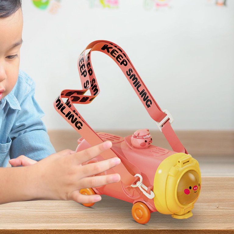 Child playing with a toy scooter on a wooden surface