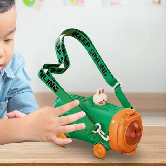 Child playing with a green toy train on a wooden surface